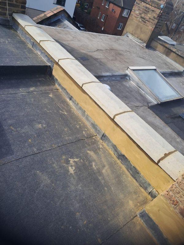 Flat roof with a rooflight and coping
