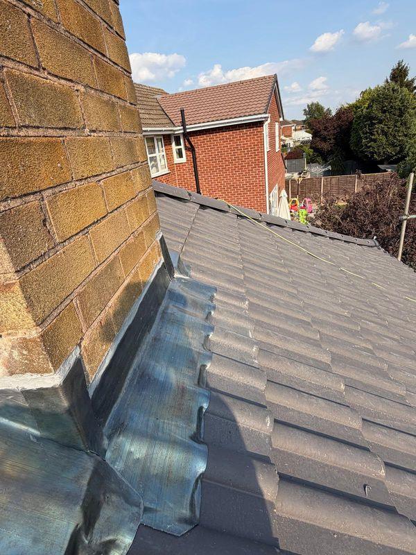 Lead flashing around a brick chimney