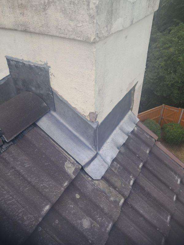 Lead flashing around a rendered chimney