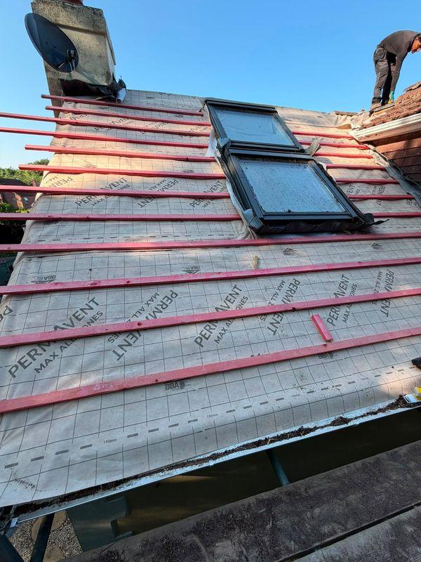 Roof window being fitted on a re-roof